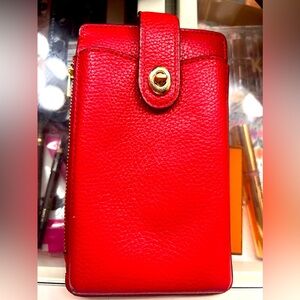 Coach wallet. Phones fit if their cover isn’t big…